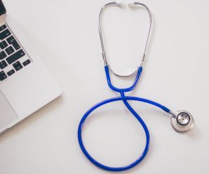 Stethoscope on desk to represent publich health.